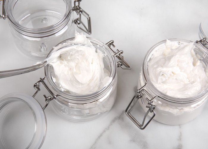 scooping body butter into jars | bramble
berry